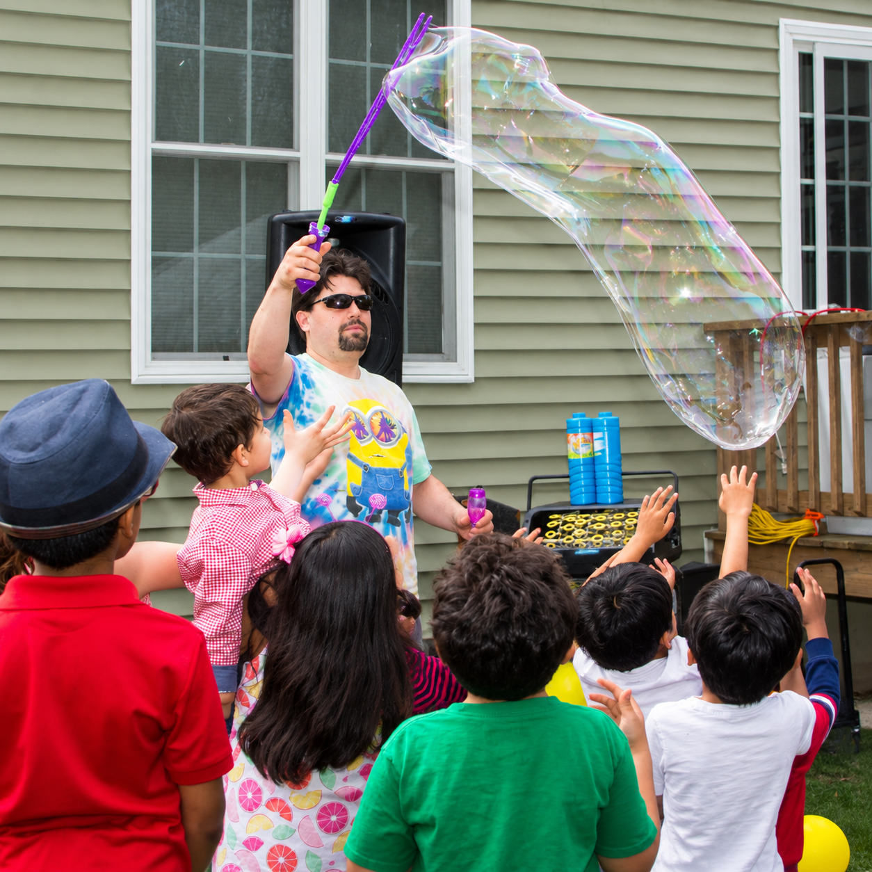 Children watching a giant bubble demonstration during a Bubble Party Pros event in Massachusetts