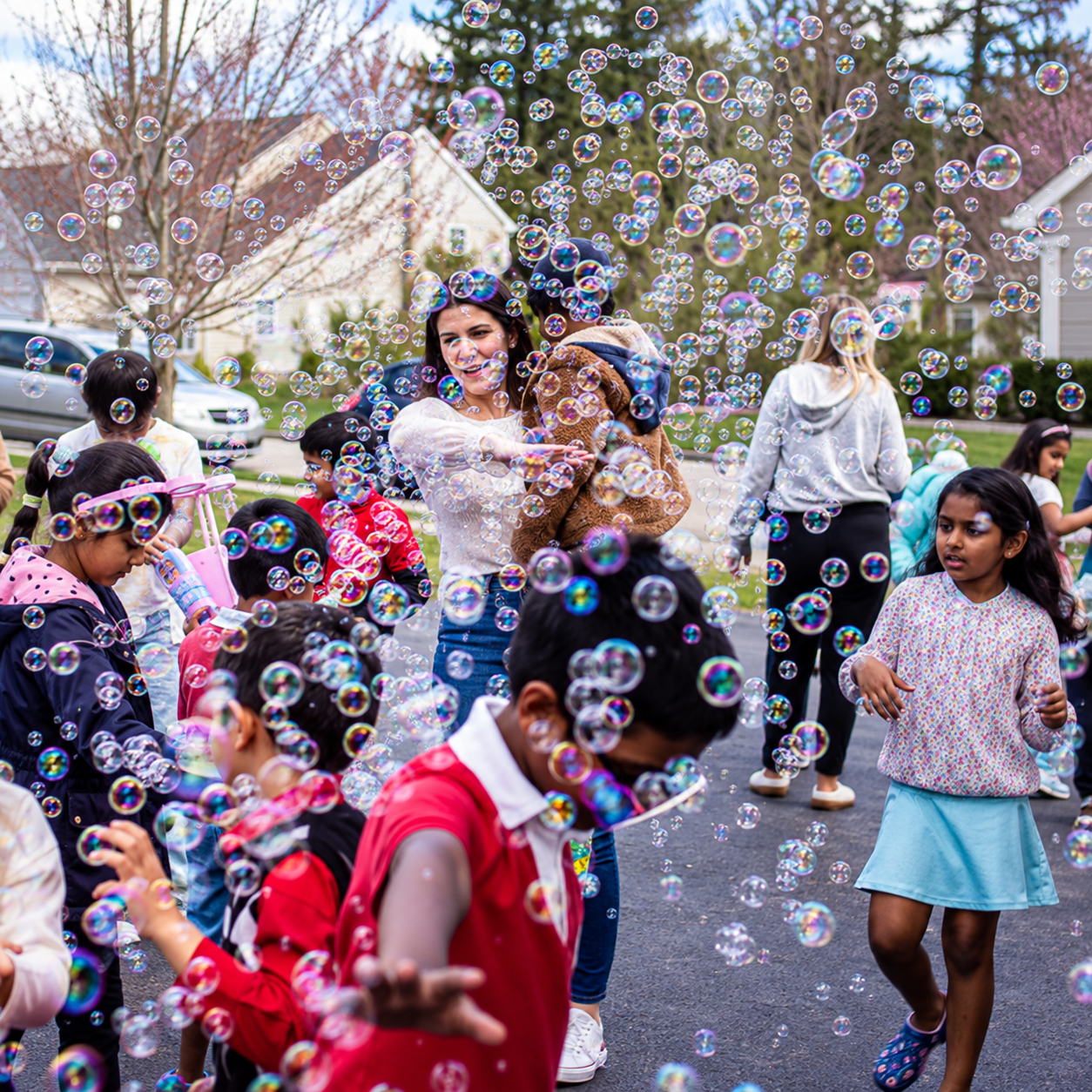 Children playing in bubbles during an outdoor Bubble Party Pros event in Massachusetts