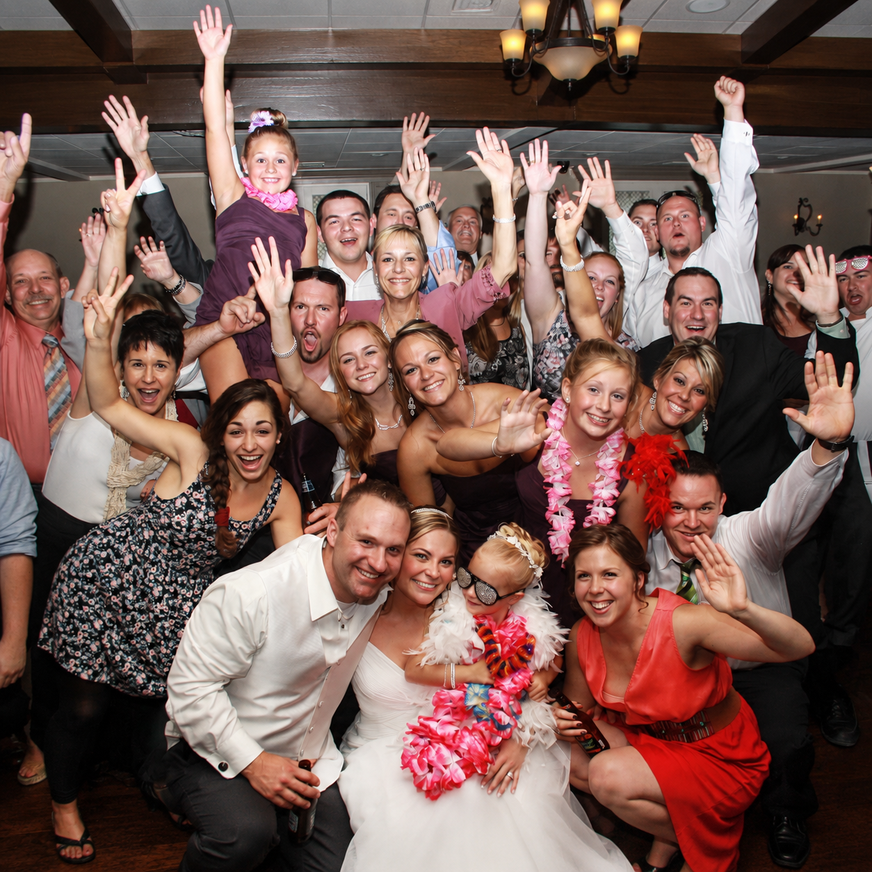 Wedding guests celebrating together on a packed dance floor during a Magic Mike Entertainment event in Massachusetts
