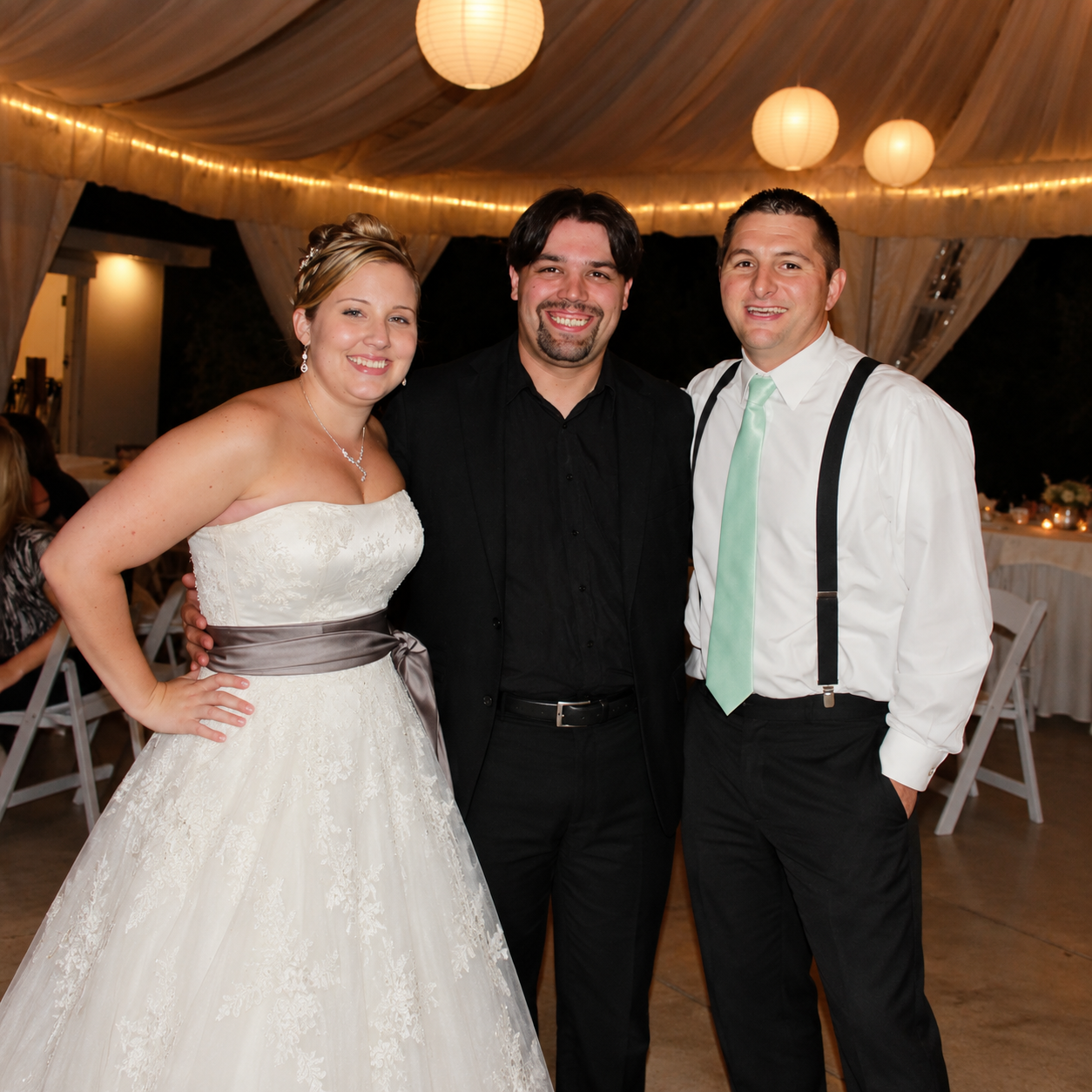 Mike from Magic Mike Entertainment with a bride and groom at a wedding reception