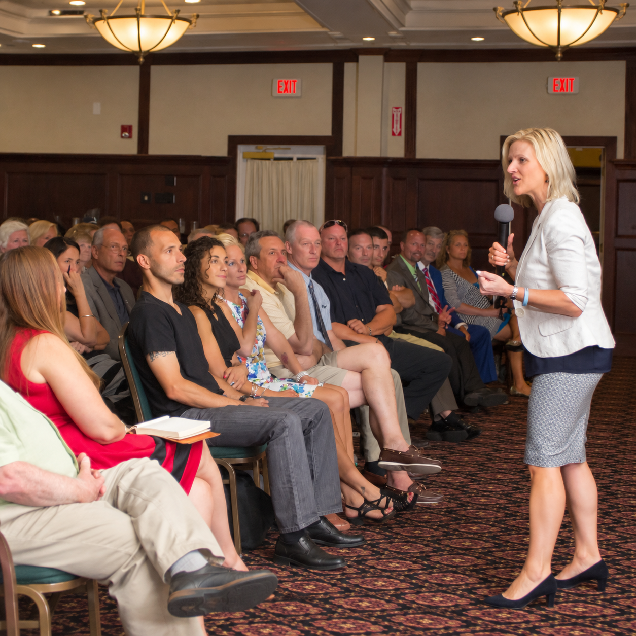 Speaker addressing an audience during a professional corporate event presentation in Massachusetts